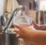 Close up of children hands, pouring glass of fresh water from tap in kitchen - NeruLife.Ru